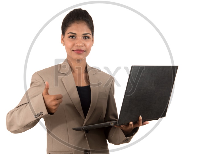 Young Indian business woman holding a laptop giving thumbs up sign