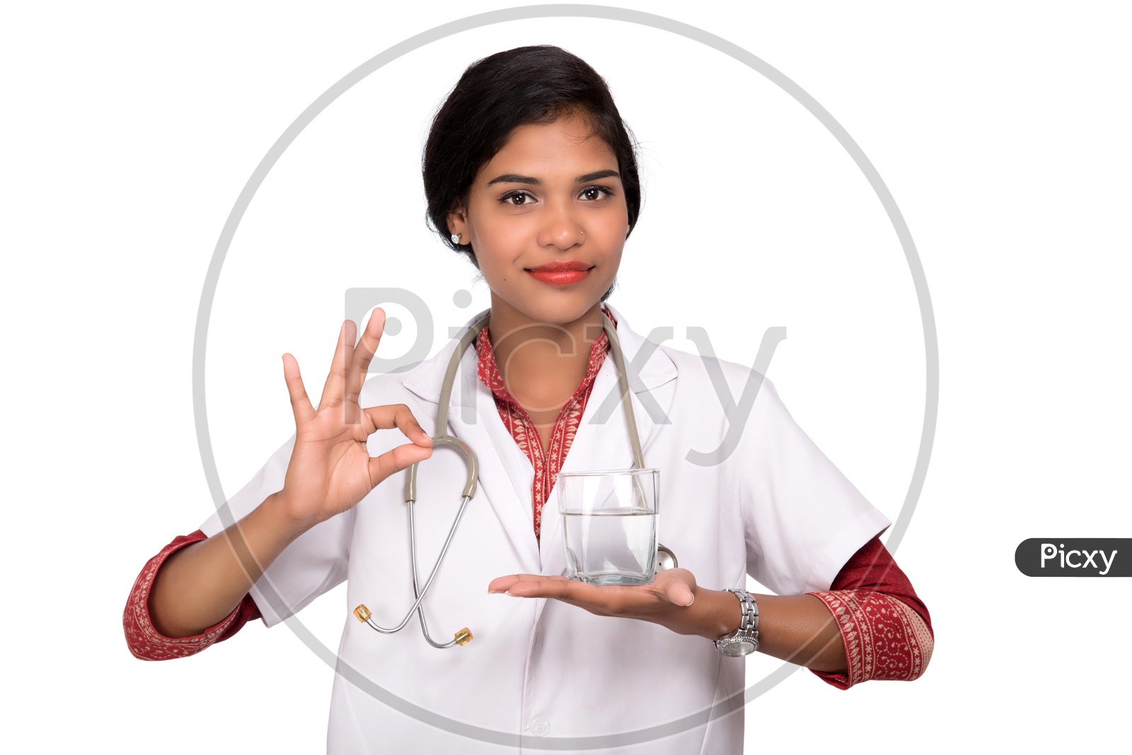 Indian Female Doctor holding a glass of water making a super sign