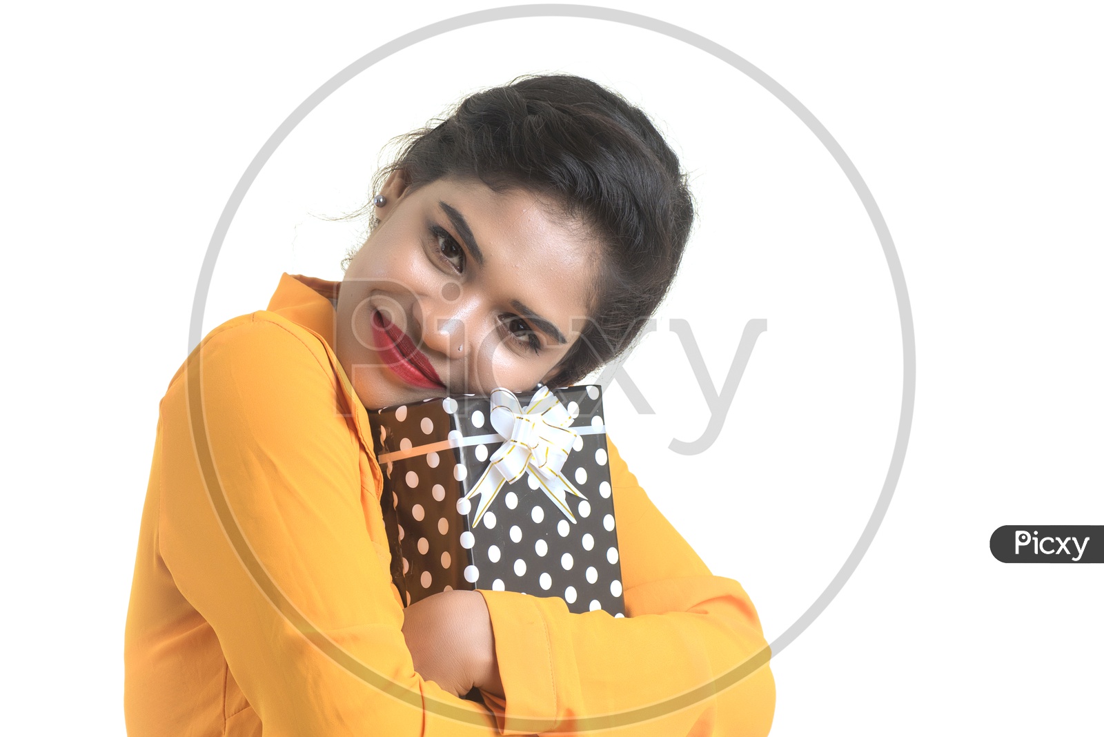 Portrait Of a Young Smiling Indian Girl Holding Gift Box On an  Isolated White Background
