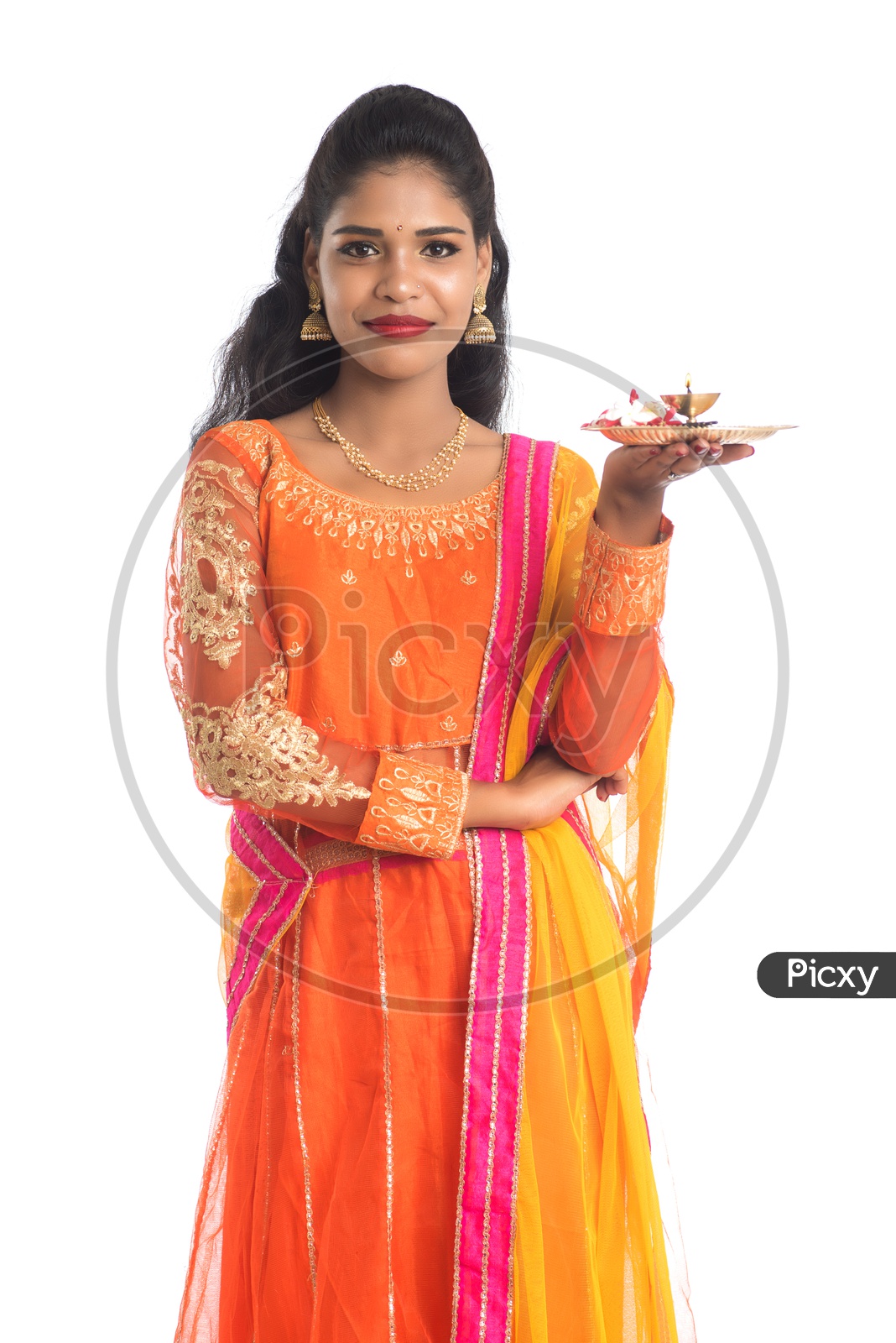 A Young Indian Traditional Woman With Pooja Thali Or Pooja Plates Holding In Hand With Smile Face On an Isolated White Background