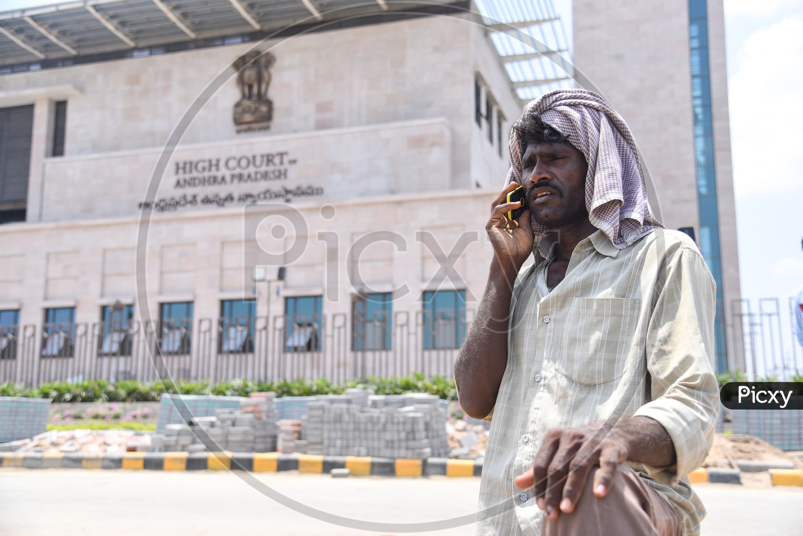 An Rural Village Man Speaking in Mobile Phone at Andhra Pradesh High Court Premise