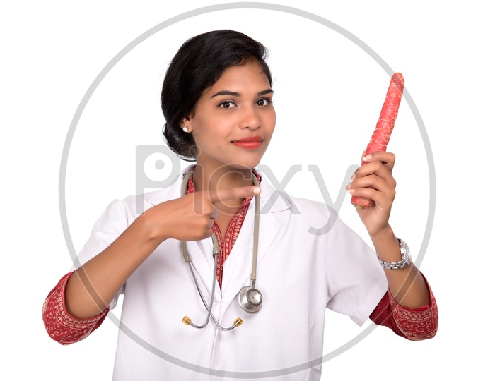 Indian Female Doctor holding carrot