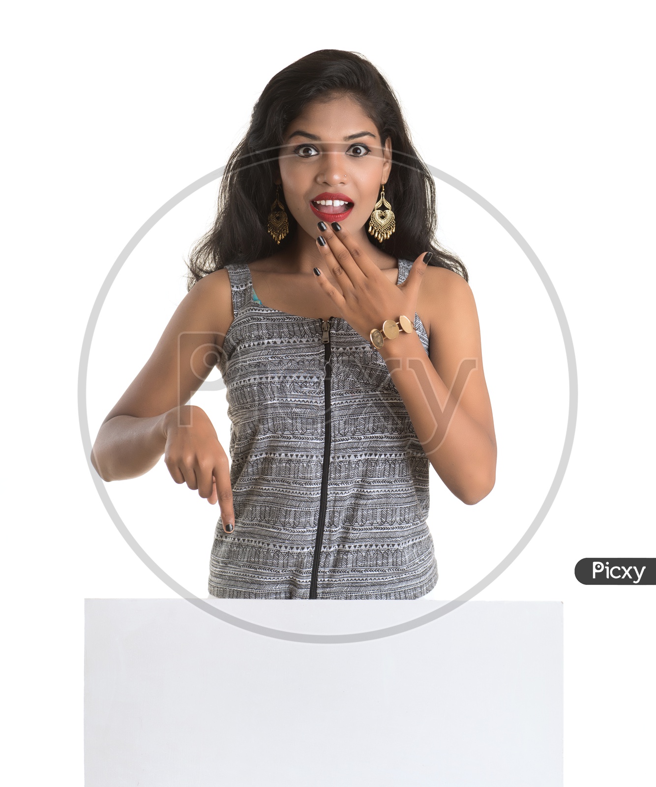 Indian woman with her hand pointing downwards a white board