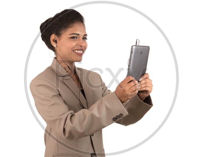 Smiling Indian business woman using a tablet smartphone