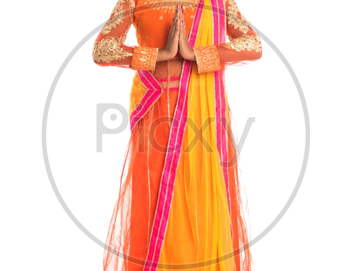 Portrait Of a Young Indian Traditional Girl Standing And Posing Gesture Namaste  With a Smile Face On an Isolated White Background