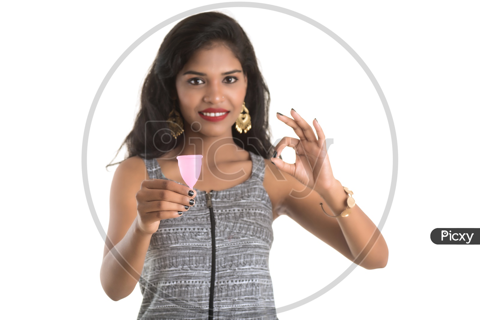 Indian woman holding a menstrual cup