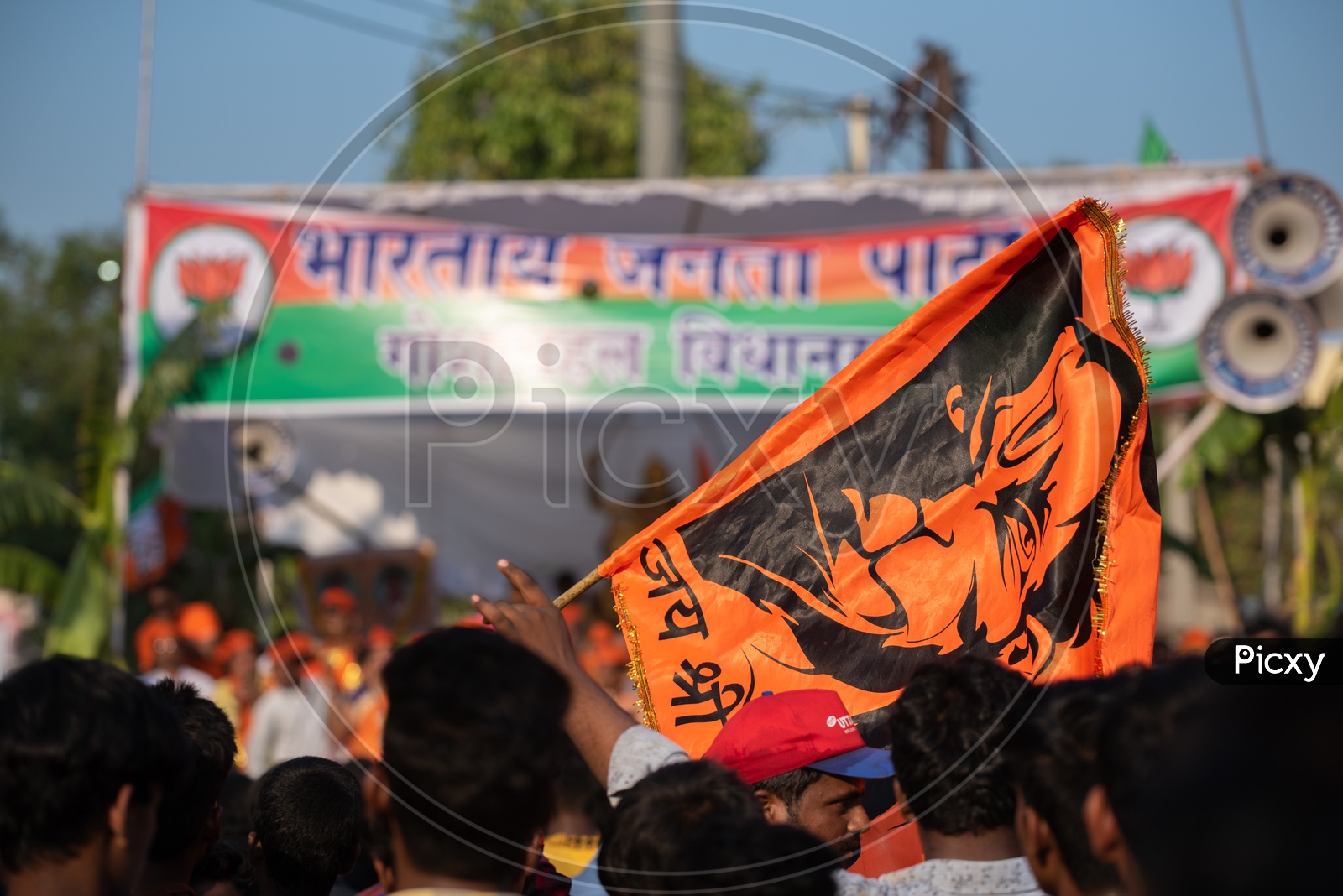 A man holding a saffron flag in a crowd at Shri Rama shobha yatra in Hyderabad