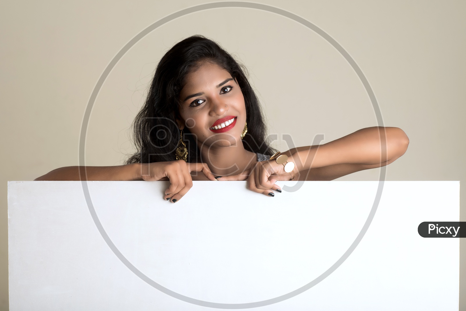 Indian woman smiling holding an empty white board