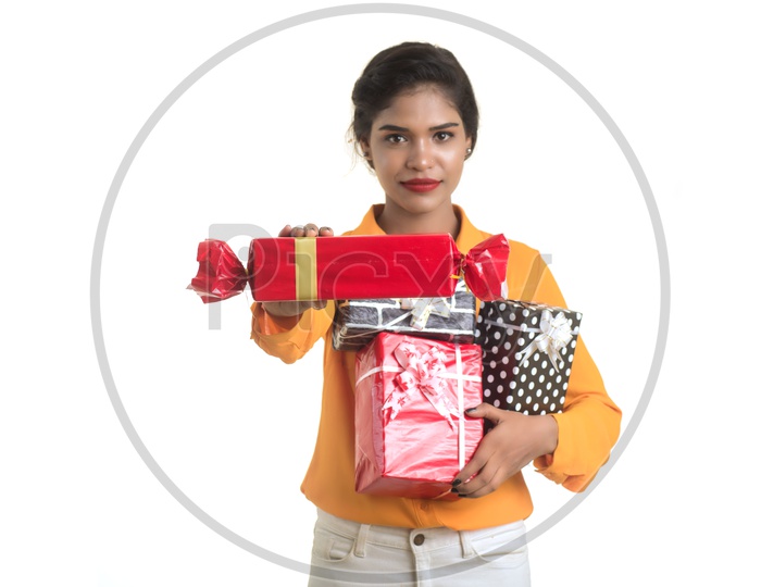 Young Girl Holding Gift Boxes in Hand with Smile On her Face On an Isolated White Background