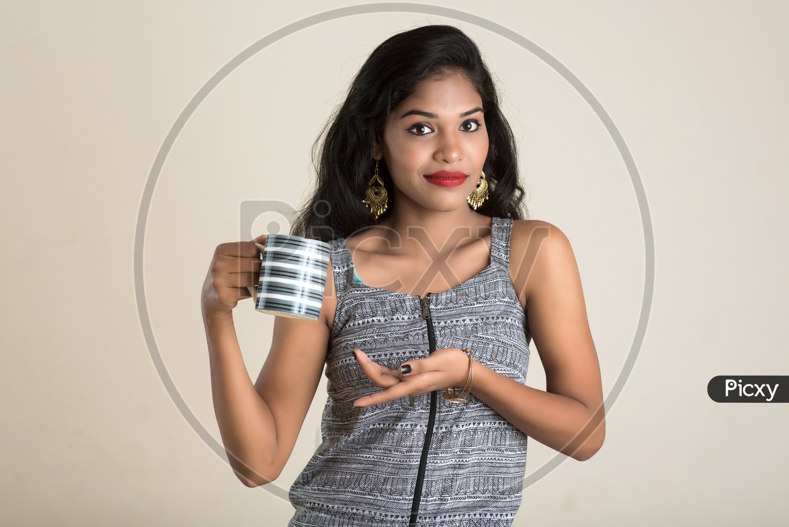 Indian woman holding a mug