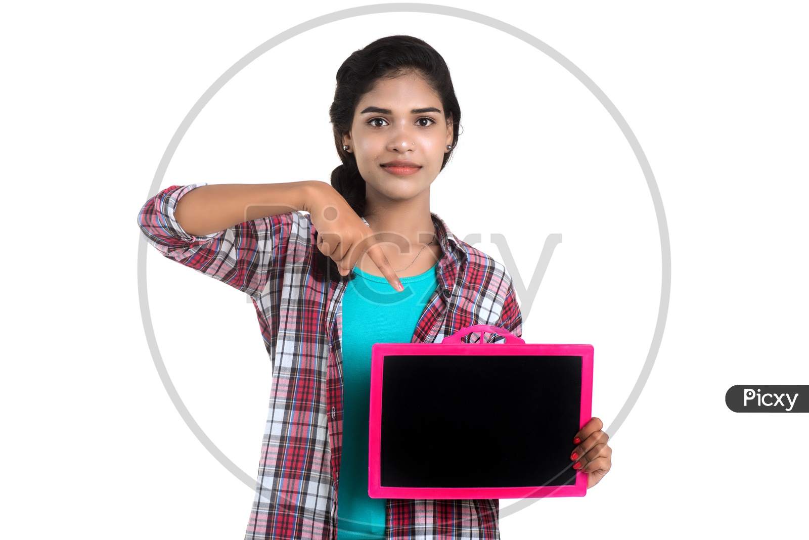 Young Indian Girl Showing Blank Slate Board And Pointing The Empty Space on an Isolated White Background