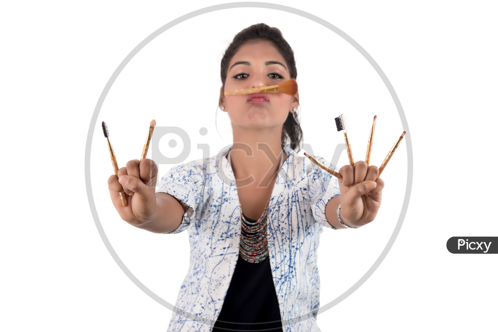 Young Beautiful Girl Enjoying With Makeup Brush On an Isolated White Background
