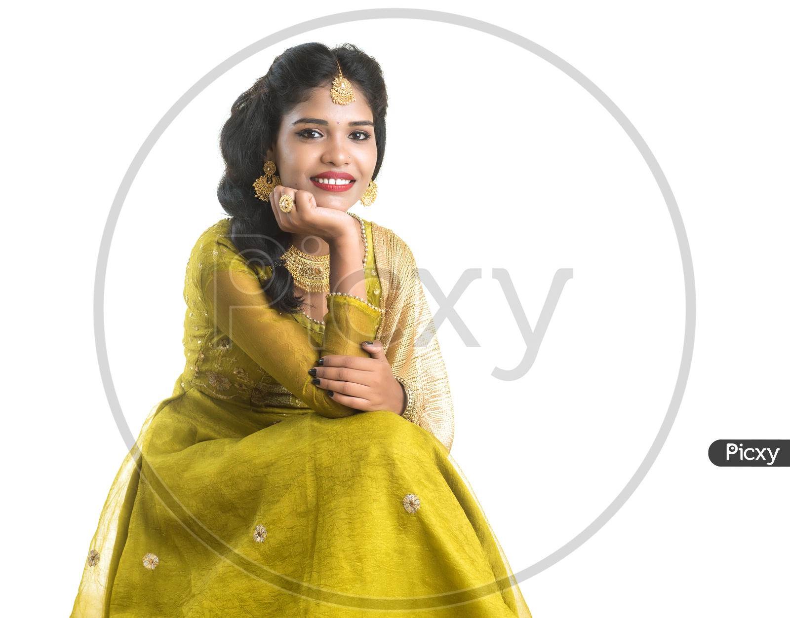 Portrait Of a Traditional  Beautiful Indian woman In Elegant Look Sitting and Posing Over White Background