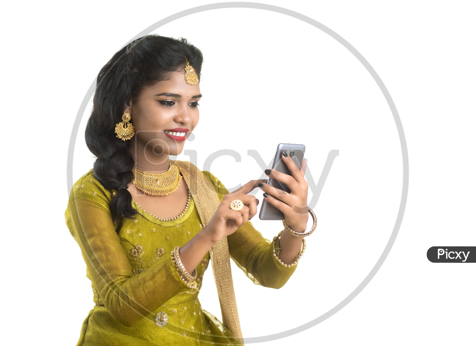 Young Traditional Indian Girl  Using  Mobile phone Or Smart Phone With Smile On Her Face On an Isolated White Background