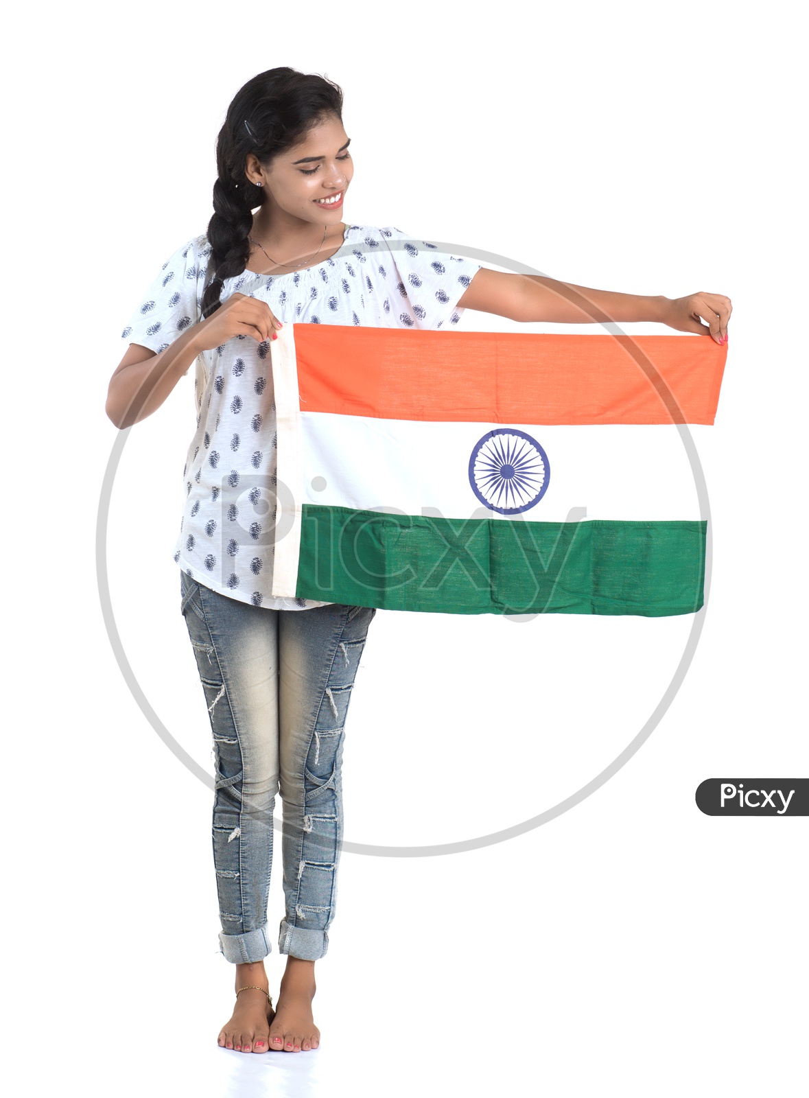 Young Indian Girl Holding Indian National Flag On Hand standing and Posing Over a White background