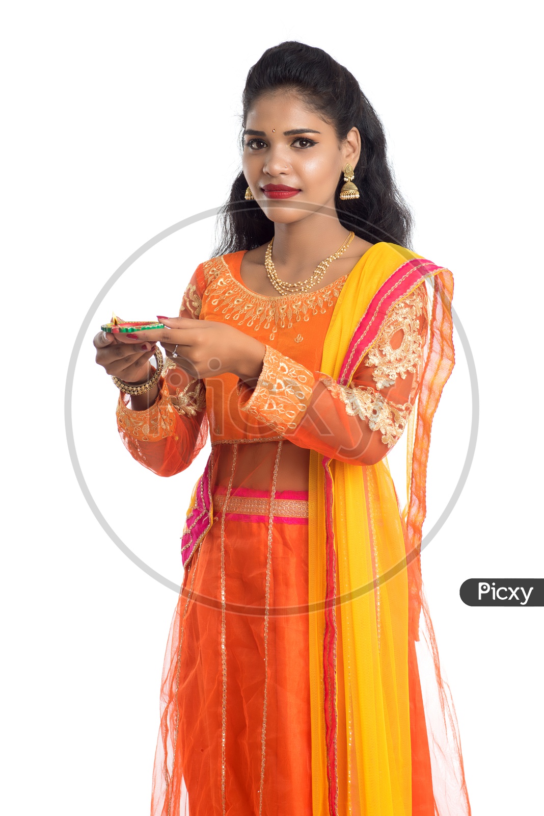 A young traditional pretty Indian woman holding diya in hand