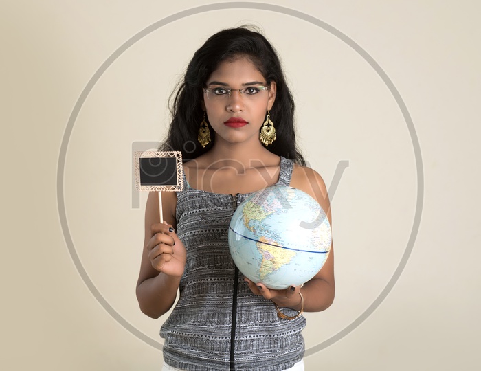 Indian woman holding a globe and a cutout board