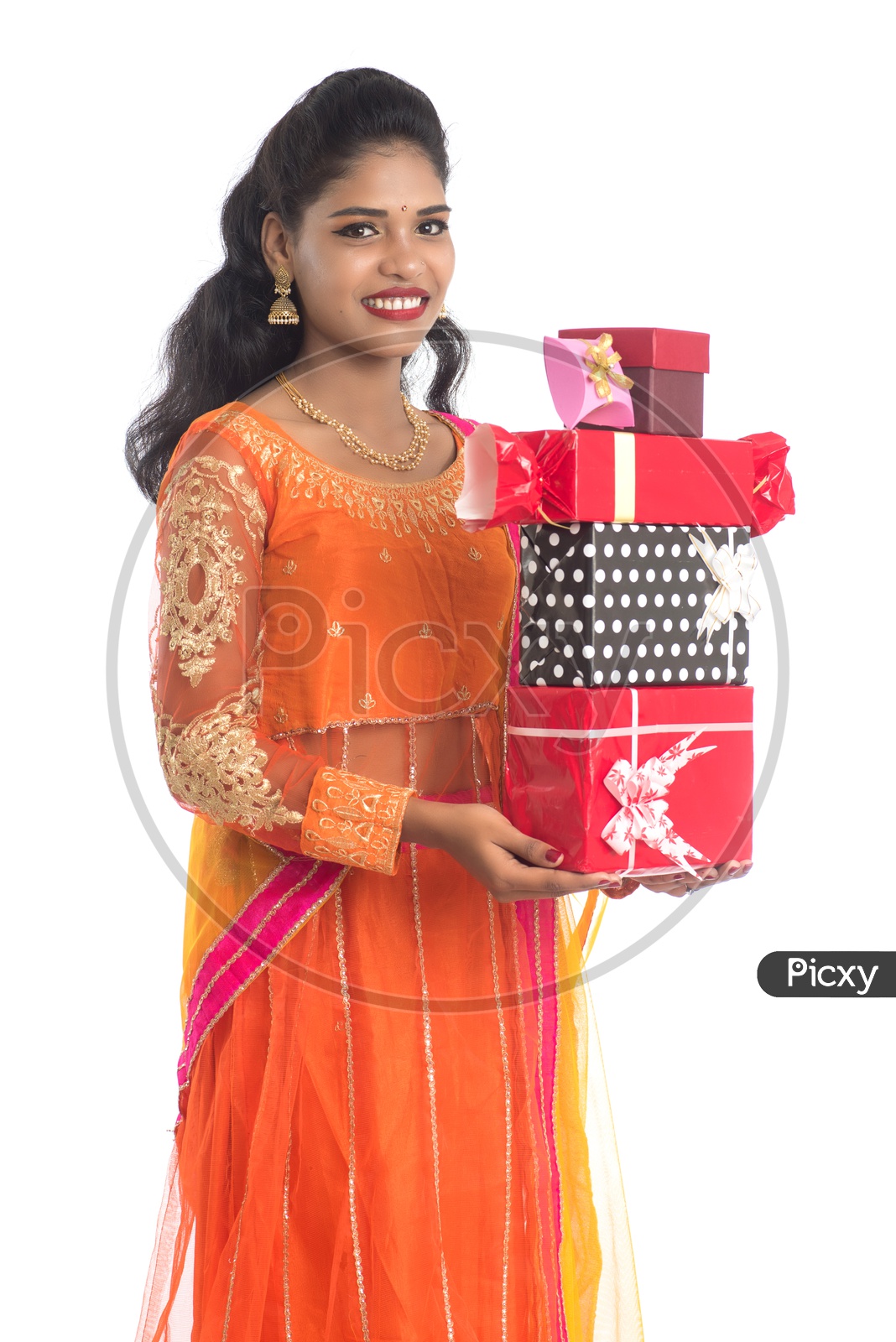 Young Traditional Indian Woman Holding Gift Boxes or Festival Gift Boxes  In hand With a Smile Face On an Isolated White Background
