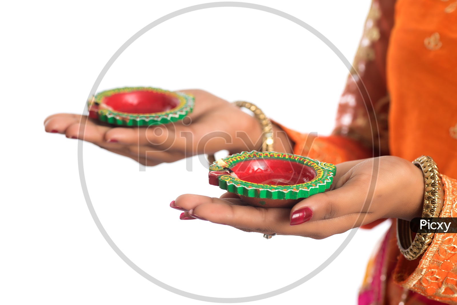 A young Indian woman holding Diyas in hand