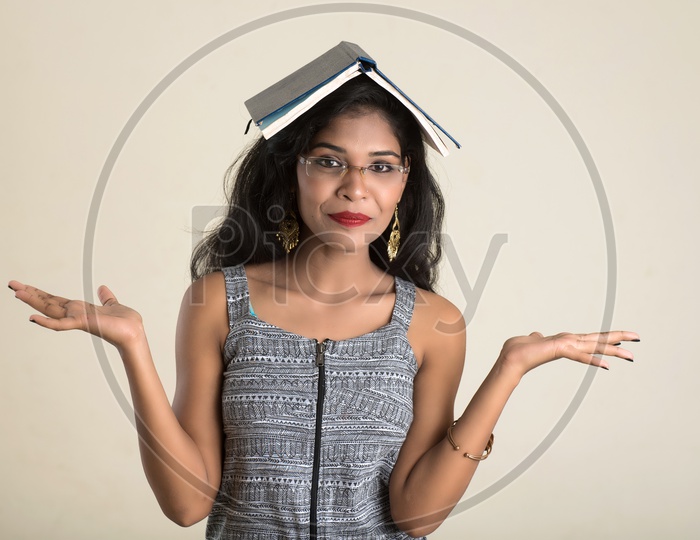 Indian woman with a book on her head