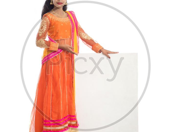 Young Traditional Indian Woman Holding Blank Board With Empty Space And Posing On an Isolated White Background