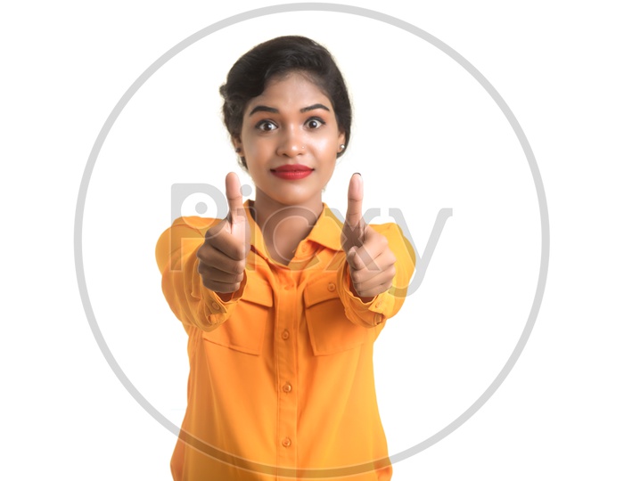 Indian woman wearing makeup with orange shirt giving thumbs up