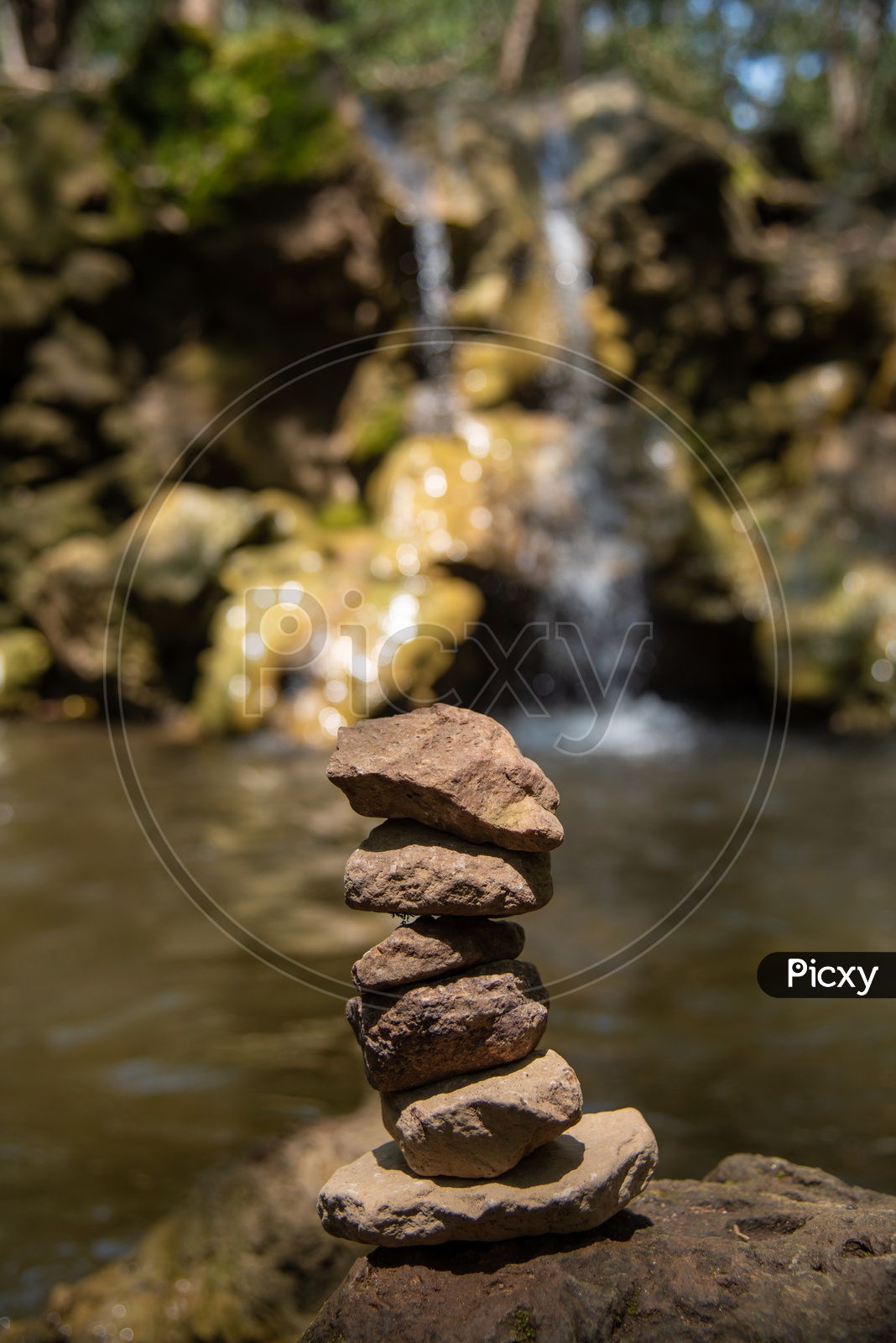 Stacked stones near a waterfall