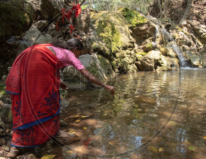 A woman devotee worshipping water at Gubbala Mangamma Thalli Temple