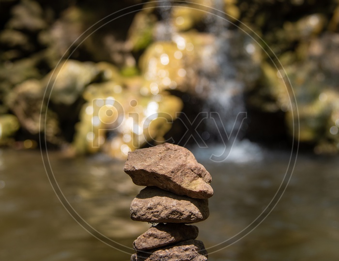 Stacked stones near a waterfall