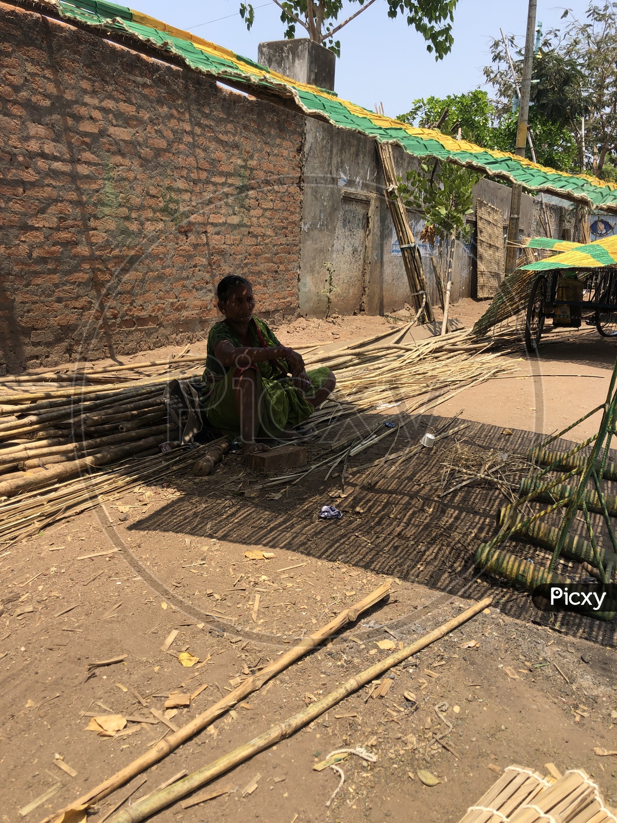 Indian Woman sitting under the bamboo shade