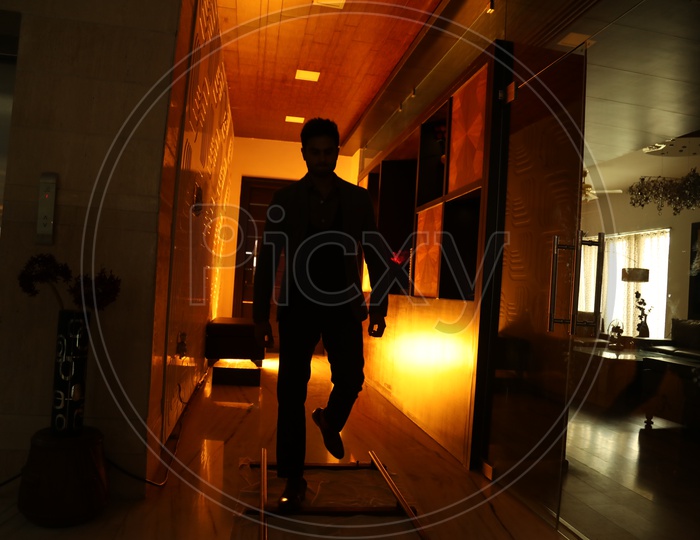 Silhouette Of a Man Walking On a House Corridor
