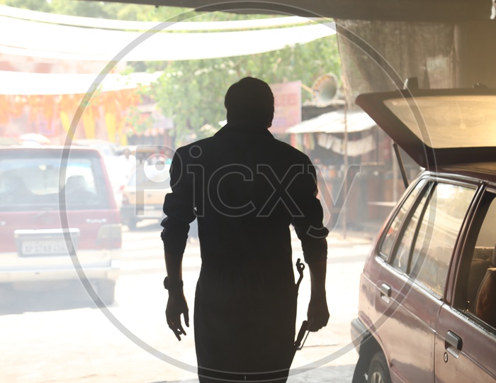 Silhouette Of A Mechanic In a Garage