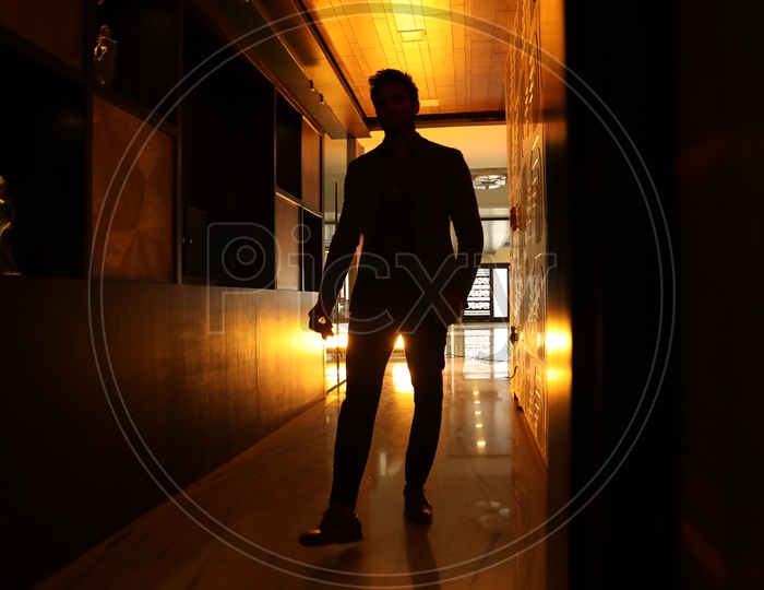 Silhouette Of a Man Walking On a House Corridor