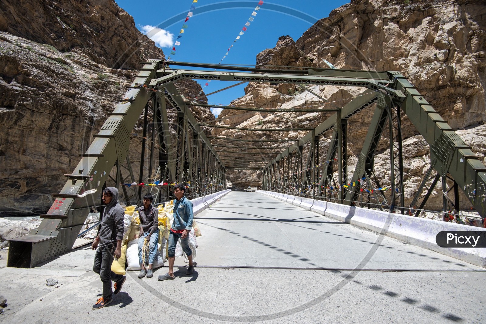 People walking on a truss bridge over a river in Hangrang valley