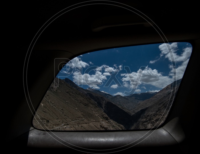 View of the cold desert mountains through a car window