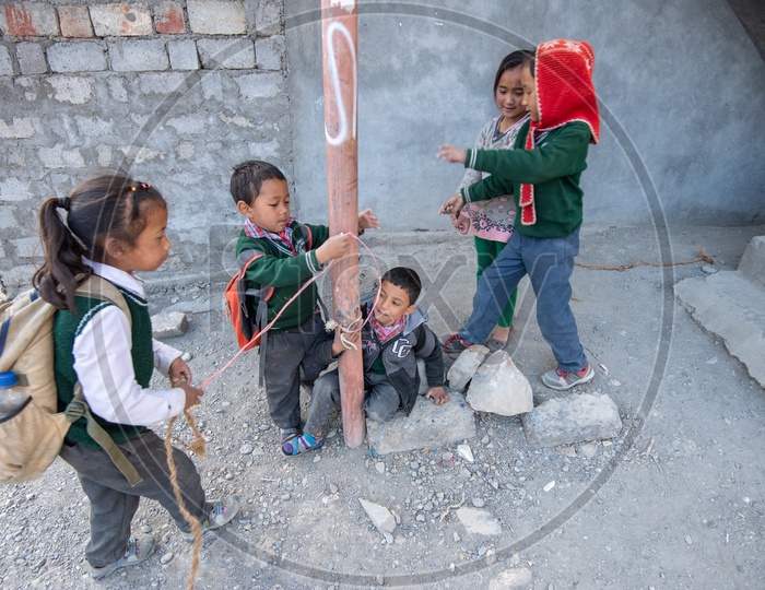 School children playing around a pole in Spiti valley
