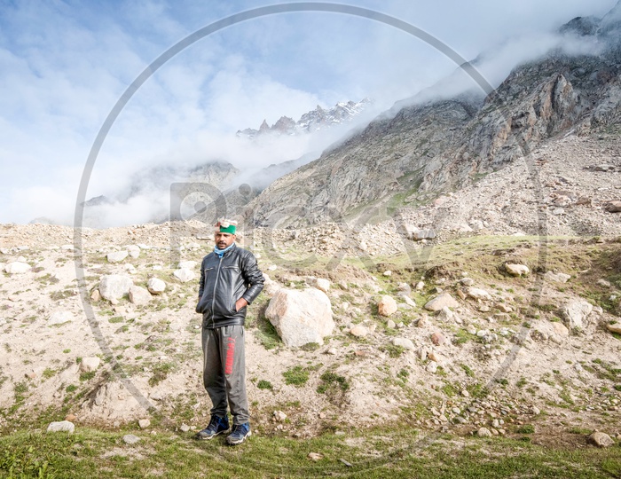 A man  standing in the barren lands of Spiti Valley