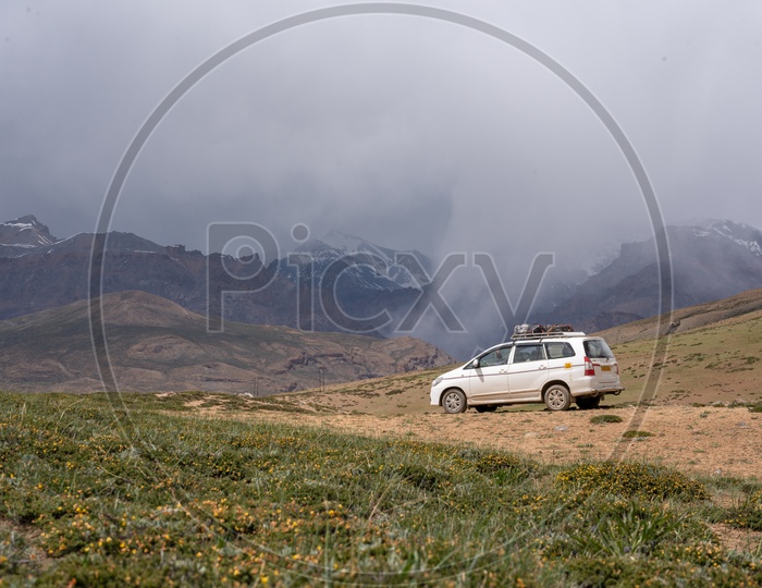 Beautiful Landscape of Snow Capped Mountains of Spiti Valley with a car in the foreground