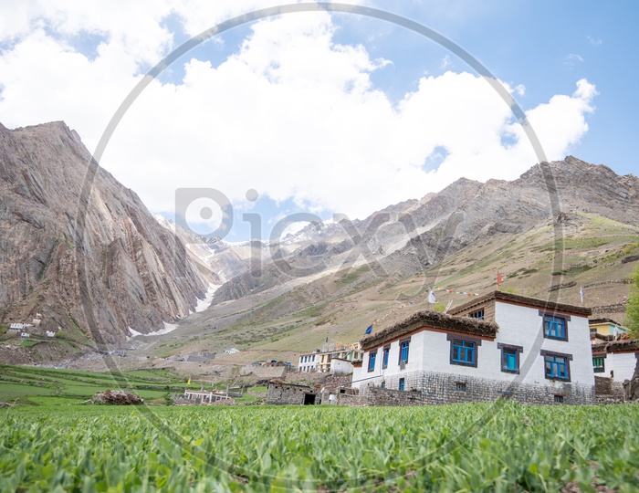 Snow Capped mountains of Spiti Valley with houses in foreground