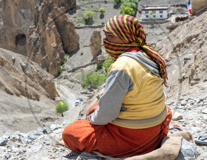 A Local Woman Siting On the Rock Hill Of Leh