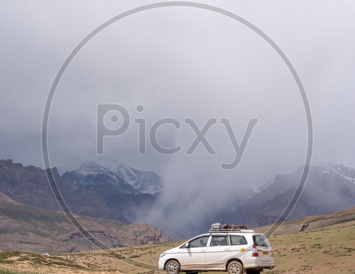 Beautiful Snow Capped Mountains of Spiti Valley with a car in the foreground