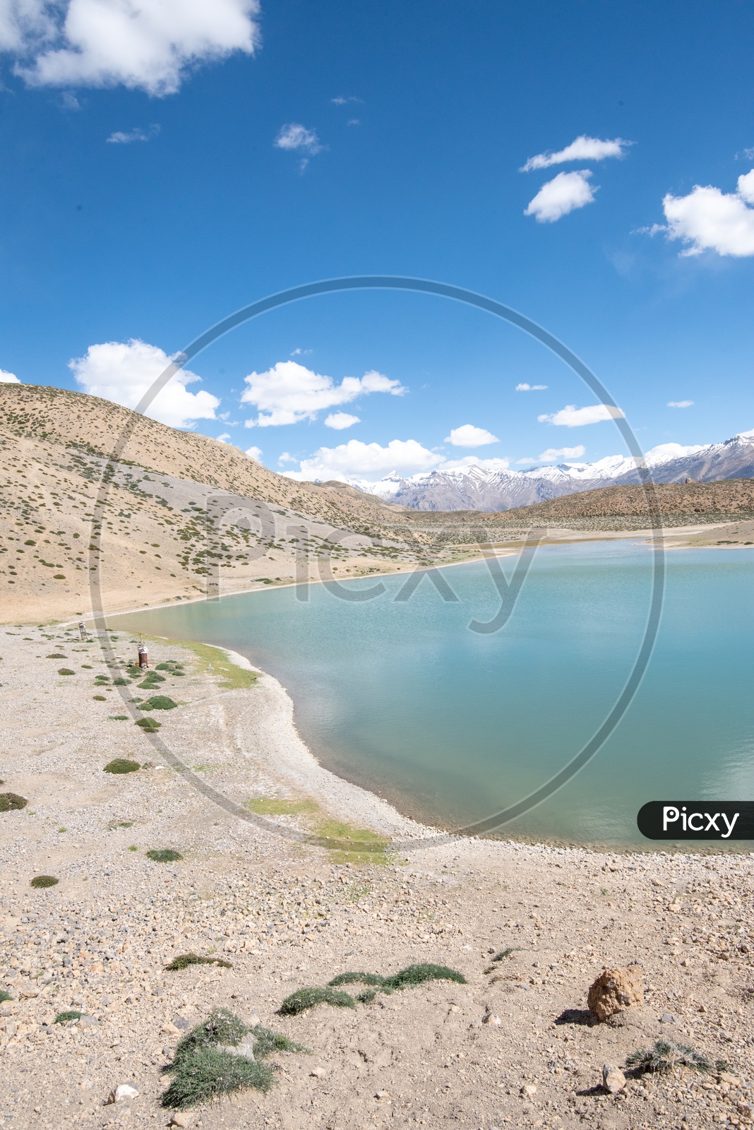 Dhankar lake with mountain peaks in the background in Spiti Valley