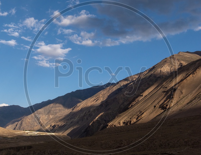 Water Flowing in the River Valleys Of Leh With Cotton Clouds In Blue Sky