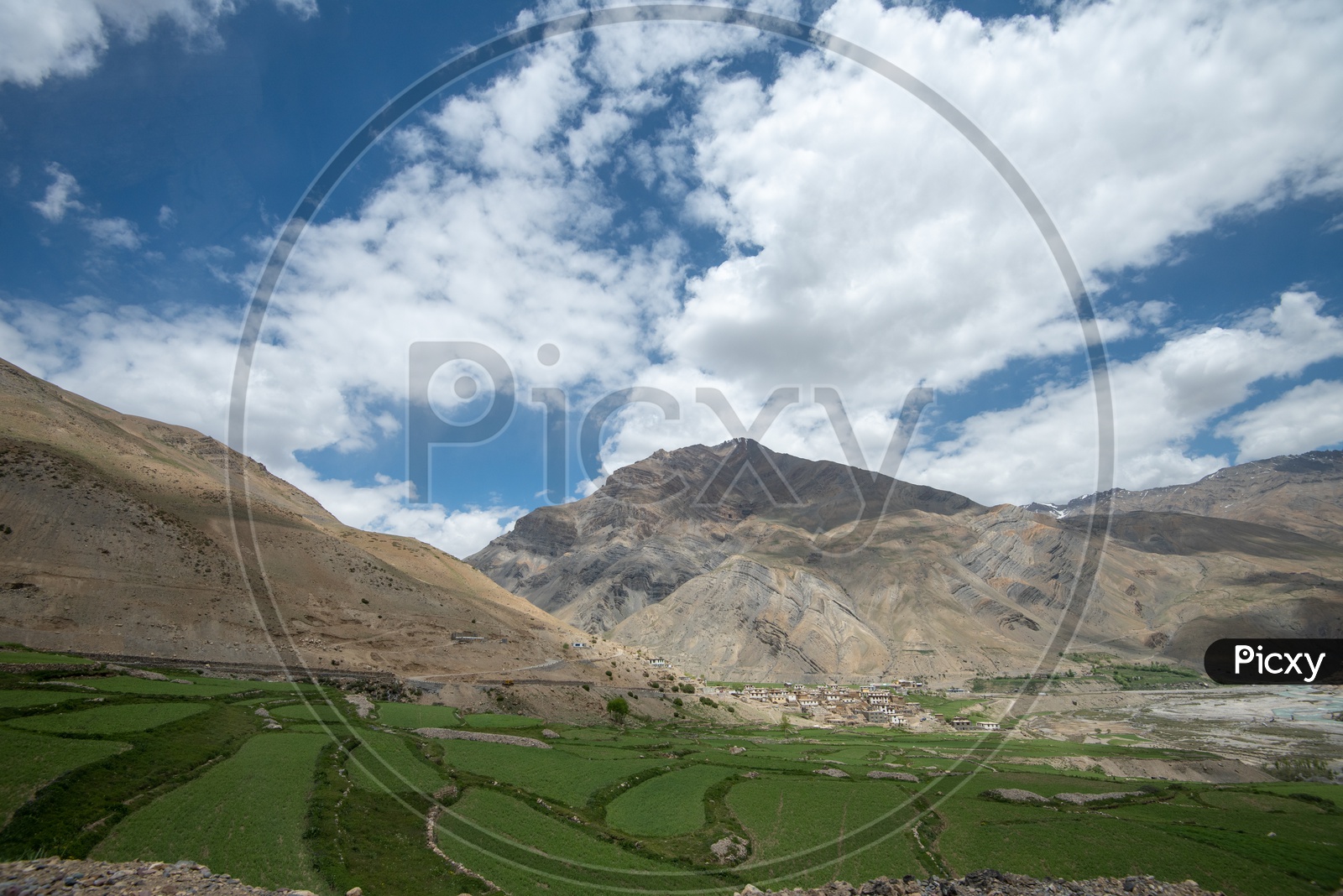 Agricultural farm lands and houses in Spiti valley with mountains in the background