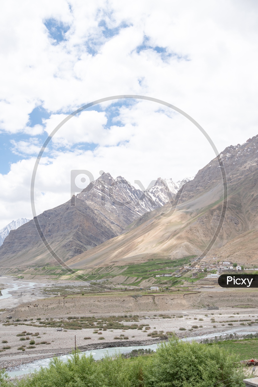Agricultural farm lands and houses beside Spiti river and mountain peaks in Spiti Valley