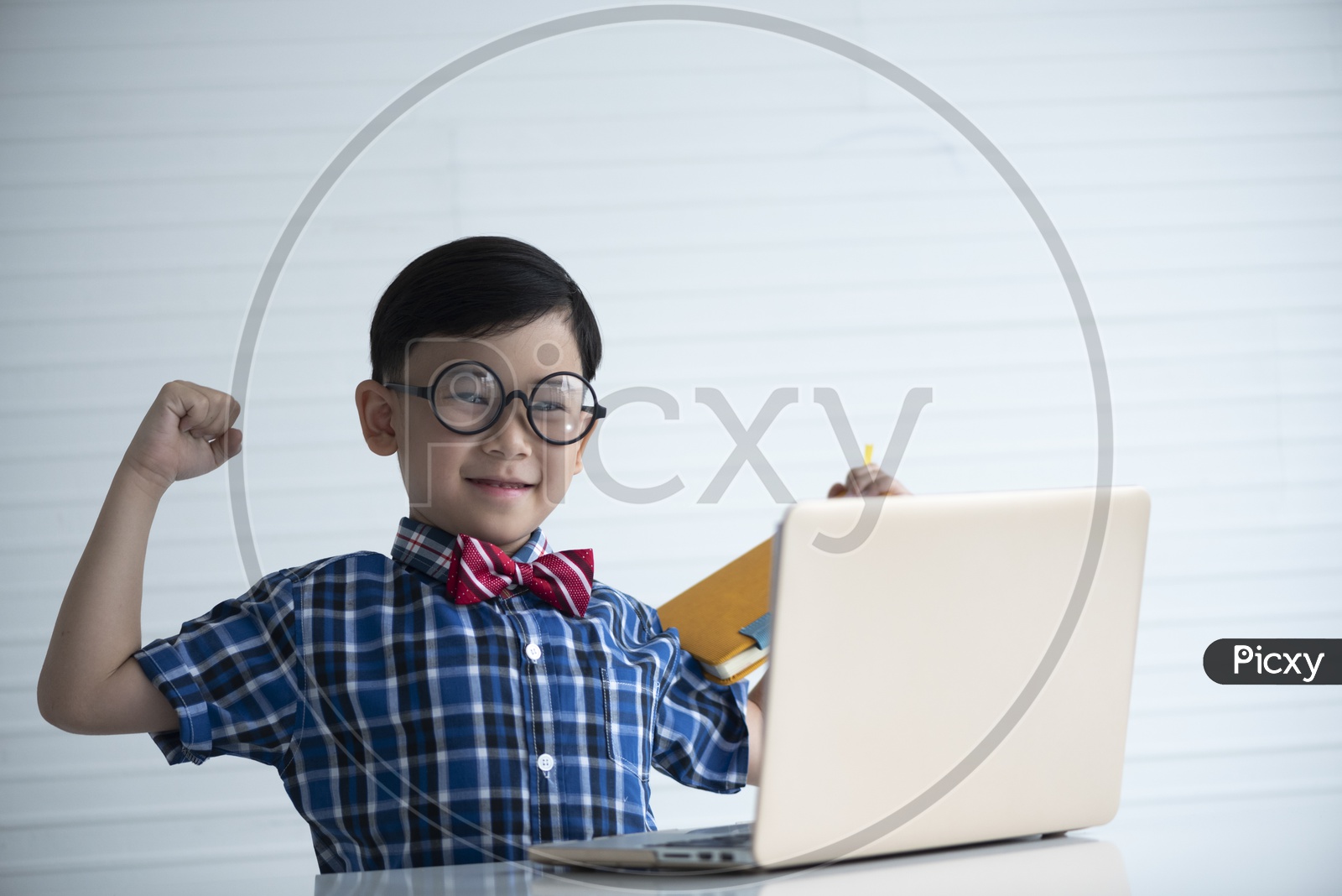 A Young Thai Boy or Child Student With a Laptop and With a Expression on Face