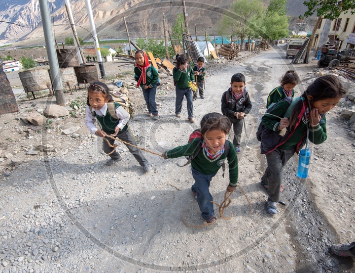 School children walking on the road in Spiti Valley