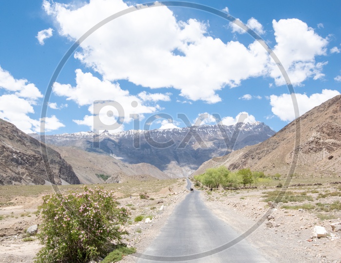 Empty Roads In Leh With a View Of Cotton Clouds In Blue Sky