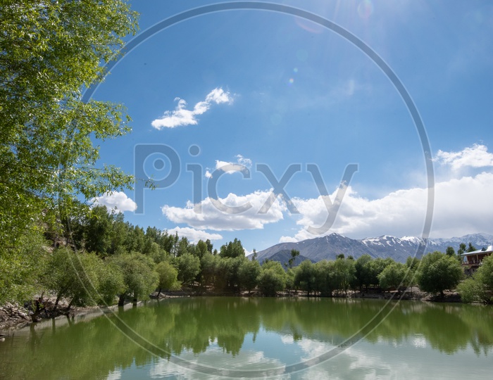 A Water Lake  at a Village In Leh  With a View Of Snow Capped Mountains