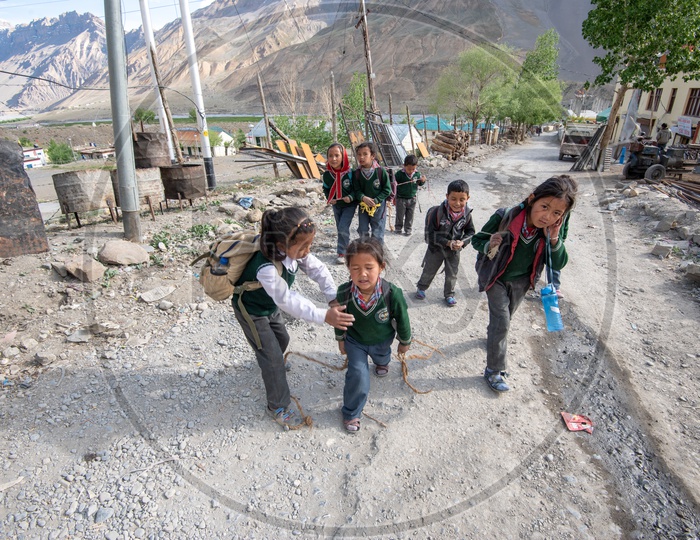 School children walking on the road in Spiti Valley